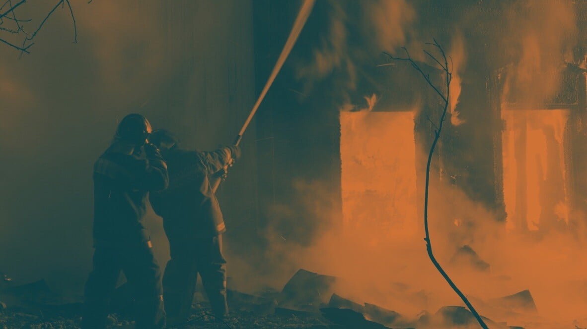 Firefighters extinguishing a home fire, demonstrating real-life fire emergency response and prevention